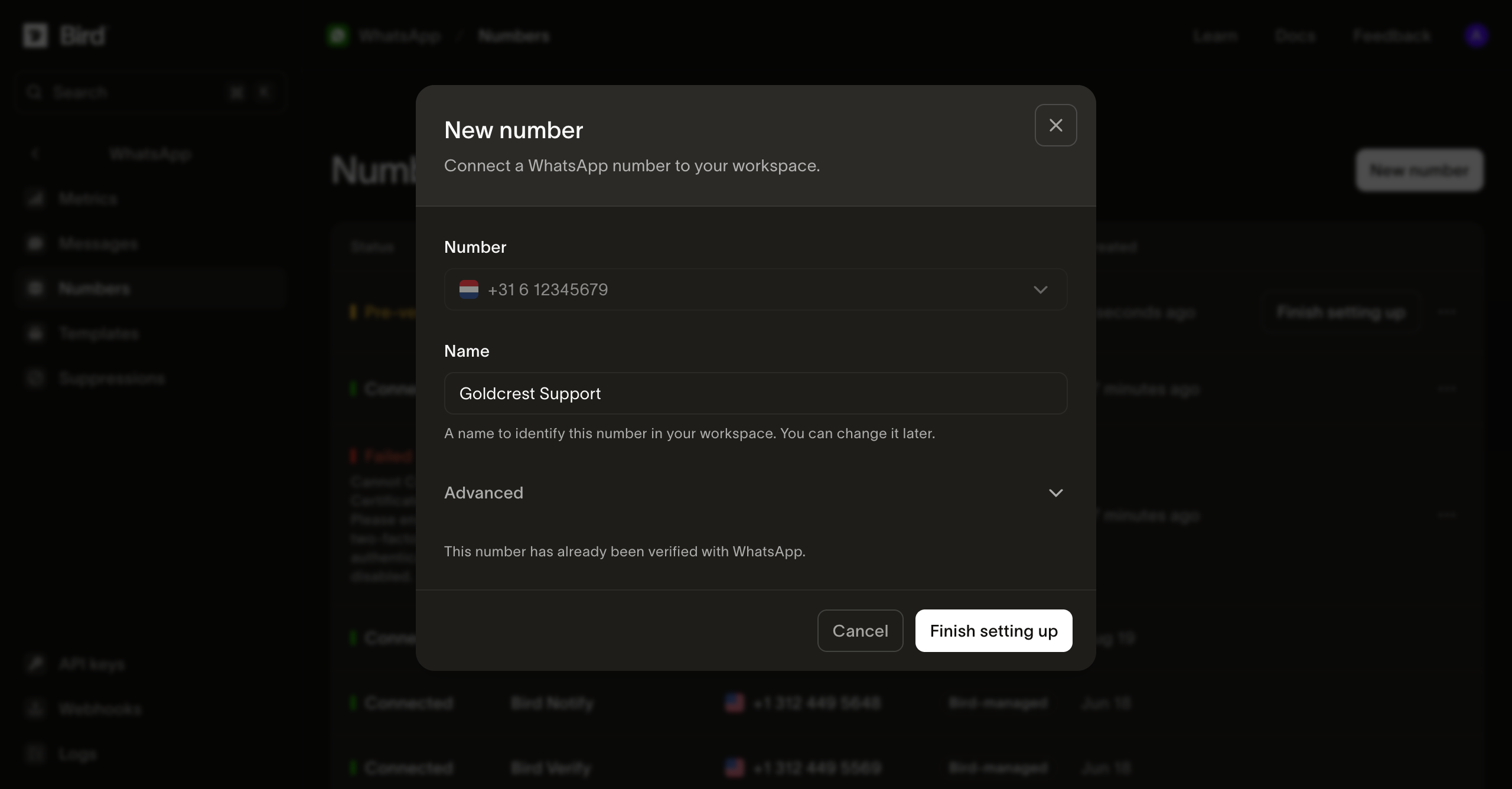 The New number dialog in the Bird dashboard after verification: the held number and a Name field, with the note "This number has already been verified with WhatsApp" above a Finish setting up button, over the dimmed Numbers list where the row now offers its own Finish setting up action